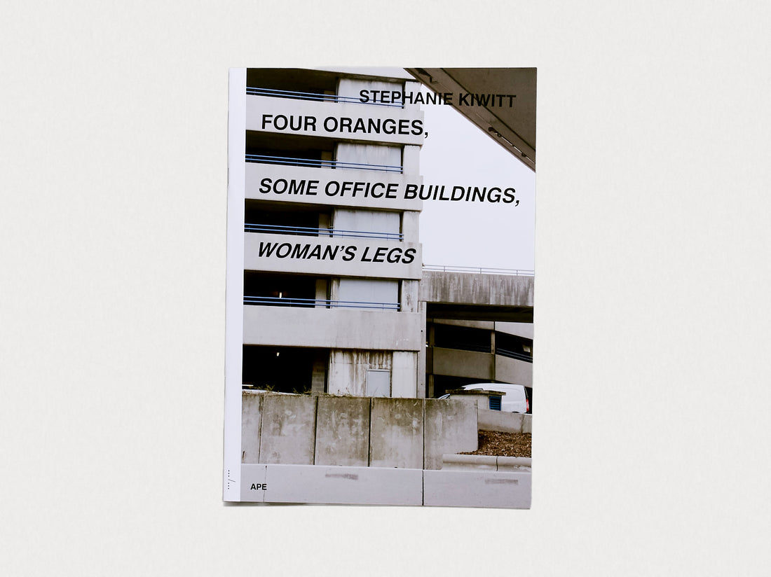 Four Oranges, Some Office Buildings, Woman’s Legs