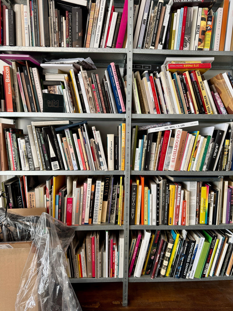 Shelves filled with art, photography, and design books from an independent distributor.