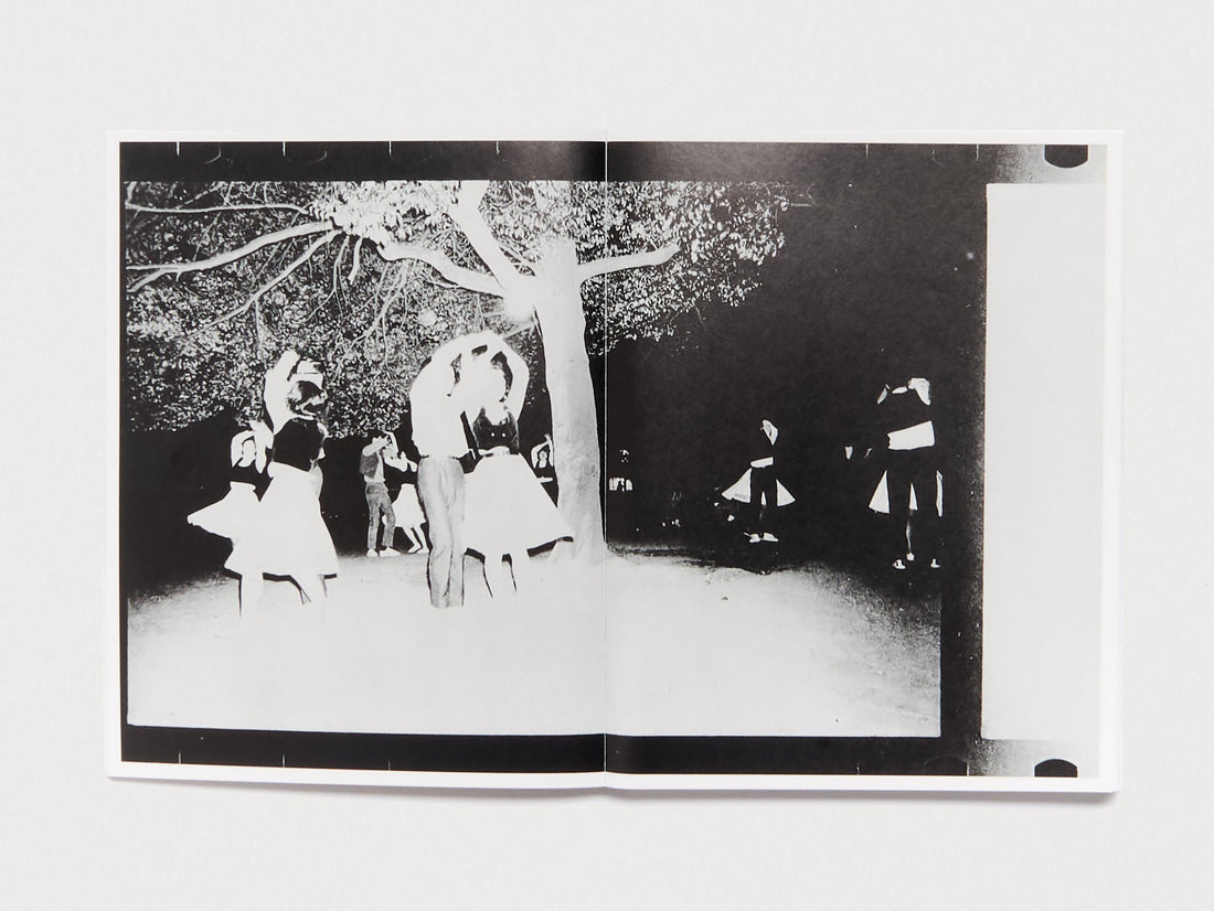 Interior spread featuring a black and white photograph of people dancing under a tree.