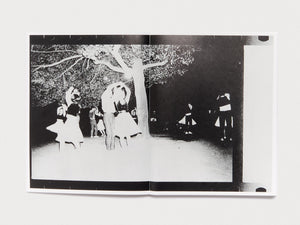 Interior spread featuring a black and white photograph of people dancing under a tree.
