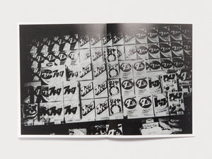 Interior spread of a photography book featuring a black and white collage of Japanese signage.