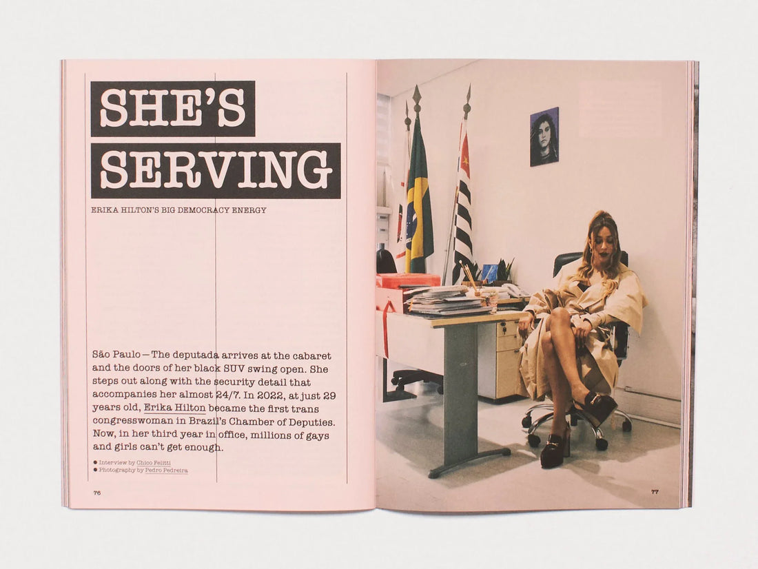 Interior spread from 'SHE'S SERVING' featuring a portrait of Erika Hilton in an office setting.