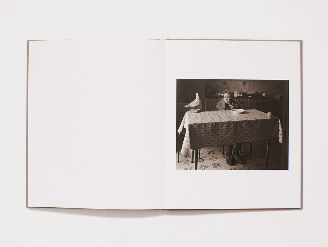 Interior spread featuring a black and white photograph of a person at a table.