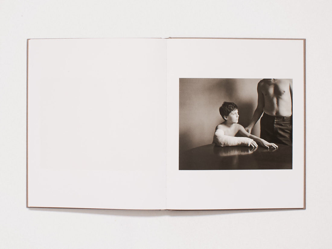 Interior spread from a photography book featuring a black and white portrait of two figures.