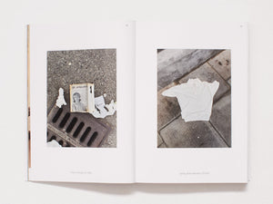 Interior spread from a photography book featuring found objects on city pavement.