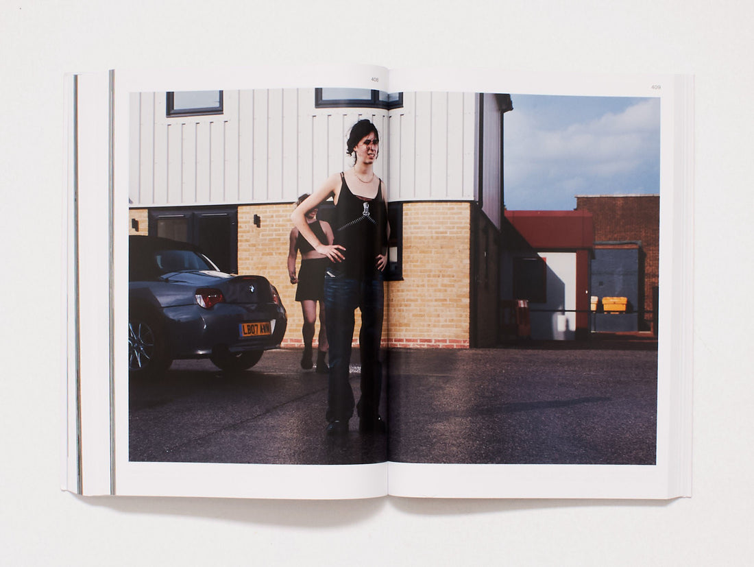 Interior spread showing a photograph of two women standing by a car in front of a building.