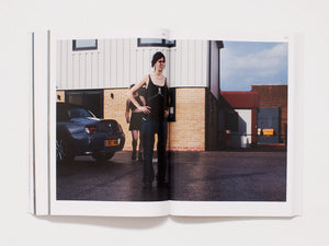 Interior spread showing a photograph of two women standing by a car in front of a building.