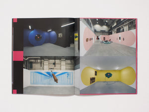 Interior spread from an art book featuring photographs of colorful installation art.