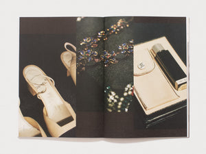 Interior spread from a book featuring fashion accessories, including shoes, jewelry, and a Chanel bag.