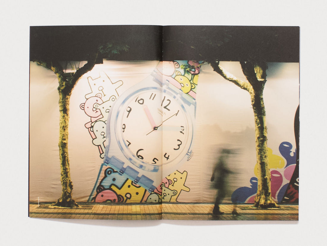 Interior spread featuring a surreal collage of a clock, cartoon figures, and trees.
