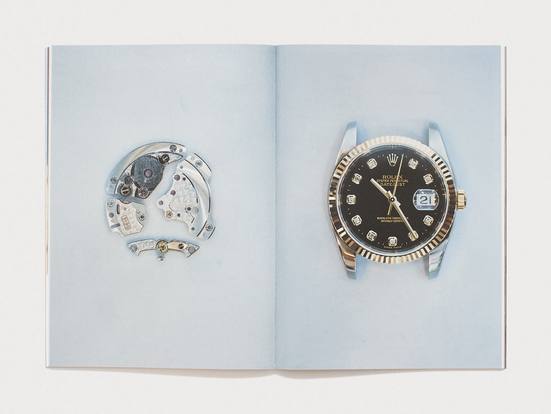 Interior spread showing a disassembled watch movement and a Rolex watch on a blue background.