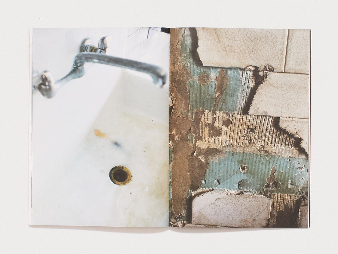 Interior spread featuring a photograph of a bathroom sink and a decayed tiled wall.