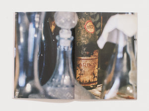 Interior spread from 'MAGAZINE' featuring close-up photography of antique bottles.