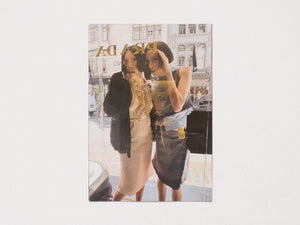 Cover of a photography book featuring two women posing on a city street with Prada signage.