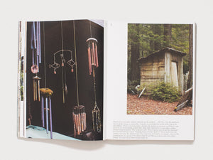 Interior spread from a photography book showing a collection of wind chimes and a small wooden shed.