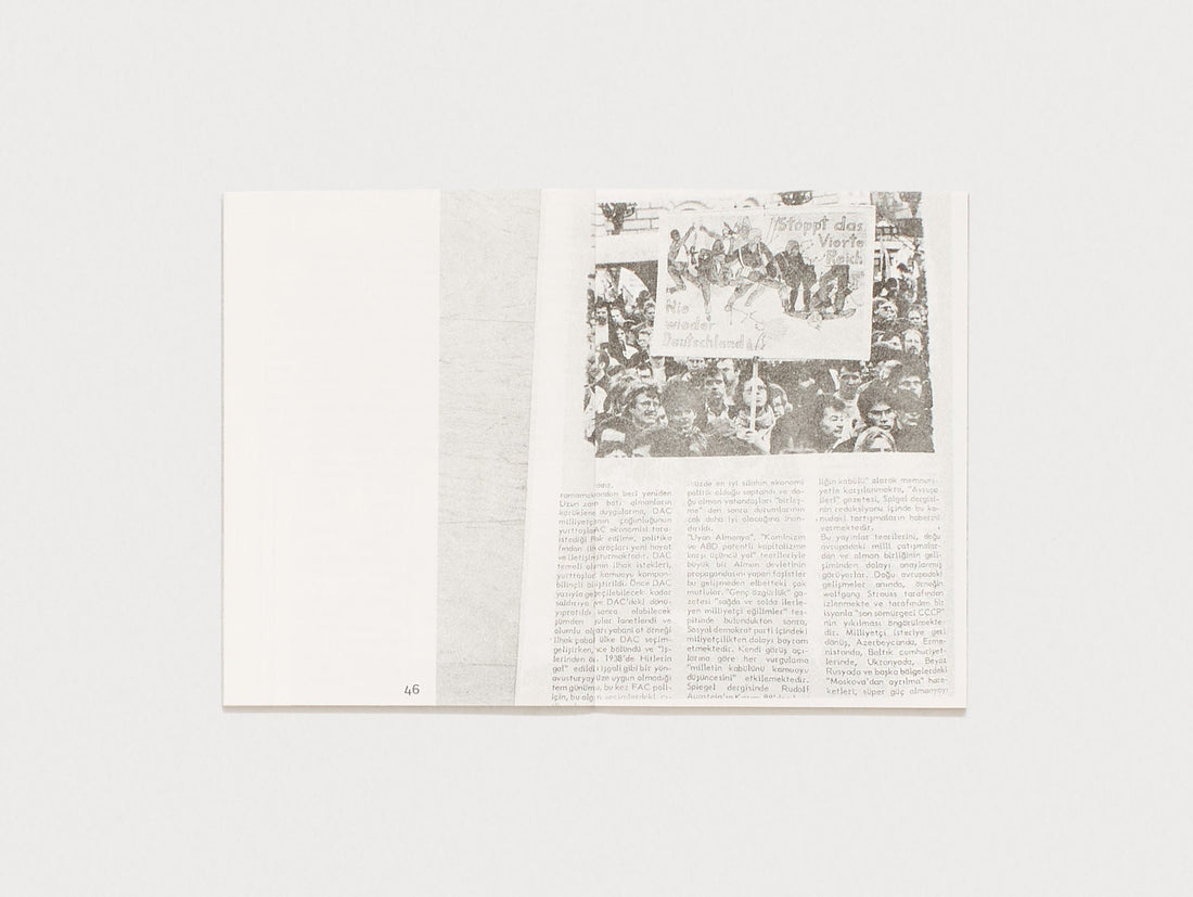 Interior spread from a book featuring a black and white archival photograph and text.